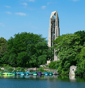 Naperville, Illinois, United States-April 24, 2014:Dock with kayaks and paddle boats in the riverwalk quarry, with bell tower, in Naperville, Illinois