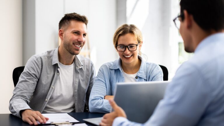 young happy couple is meeting with lawyer