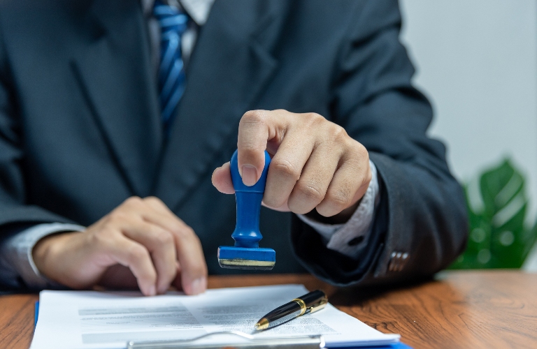 lawyer is putting stamp n the document